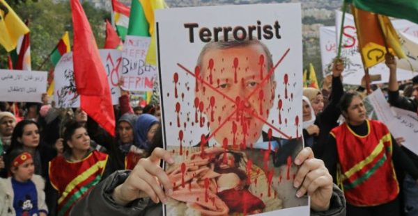 © Anwar Amro, AFP | Lebanese Kurds hold a placard of Turkish President Recep Tayyip Erdogan at a protest in Beirut in Jan. 2018.