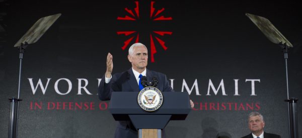 Vice President Mike Pence addresses the World Summit in Defense of Persecuted Christians as Franklin Graham watches, Thursday, May 11, 2017, in Washington. The summit is hosted by Franklin Graham, and the Billy Graham Evangelistic Association. (AP Photo/Cliff Owen)