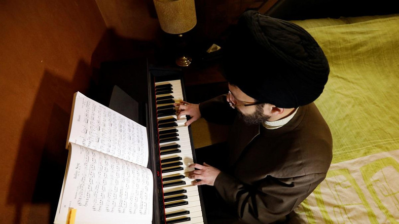Shi'ite Muslim scholar Sayed Hussein al-Husseini, 38, plays the piano at his home in Dahieh, Beirut's southern suburb, Lebanon March 22, 2018. Picture taken March 22, 2018. REUTERS/Jamal Saidi