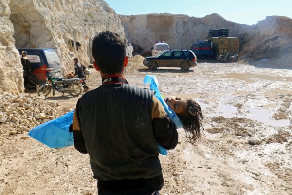 A Syrian father is shown carrying his child that was killed by the chemical attack in Douma April 8, 2018