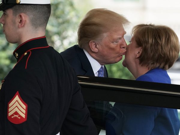 President Trump kisses German Chancellor Angela Merkel during her arrival at the White House on Friday. Alex Wong/Getty Images 