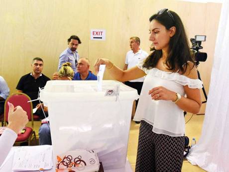 A Lebanese expat casts her vote for the Lebanese elections at the premises of Lebanese embassy in Abu Dhabi.