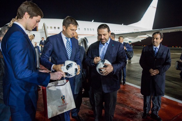 HARIRI AUTOGRAPHING A SOCCER BALL