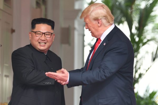 US President Donald Trump (R) gestures as he meets with North Korea's leader Kim Jong Un (L) at the start of their historic US-North Korea summit, at the Capella Hotel on Sentosa island in Singapore on June 12, 2018. Photo: AFP