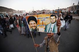 A boy holding a poster of Lebanon's Hezbollah leader and the leader of the Shi'ite Houthi movement during a rally in Sana'a, Yemen, on October 26, 2016.