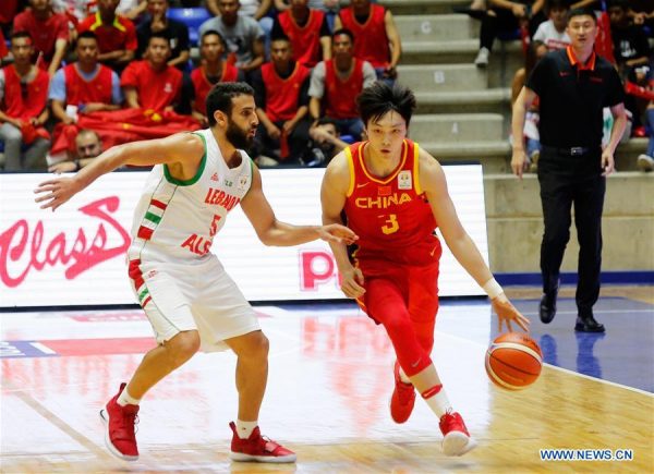 Hu Mingxuan (R) of China vies with Amir Saoud of Lebanon during the FIBA 2019 World Cup Asian Qualifiers 2nd round Group E match between Lebanon and China in Beirut, Lebanon, on Sept.13, 2018. China lost 88-92. (Xinhua/Bilal Jawich)