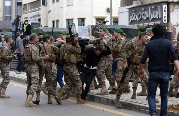 Lebanese Army personnel beat a protester in Bechara Khoury, Sunday, Dec. 23, 2018. (The Daily Star/Hasan Shaaban)