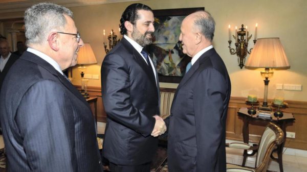 Prime Minister Saad Hariri shakes hands with former rival Ashraf Rifi as the two meet for a public reconciliation with former prime minister Fouad Siniora. Hand out image