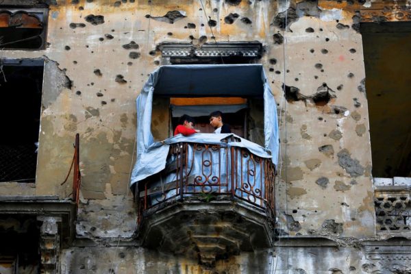 Children stand on the balcony of their apartment building that was damaged during Lebanon's 1975-1990 civil war. All photos by AP Photo