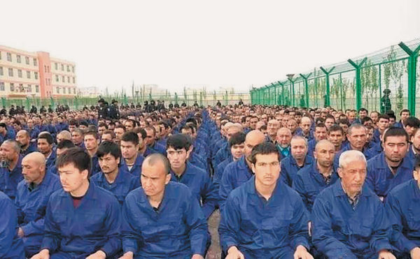 Uighur detainees listening to a “deradicalization” presentation at a   camp, in a photo posted to the Xinjiang Judicial Administration’s WeChat account, Hotan Prefecture, Xinjiang, 2017