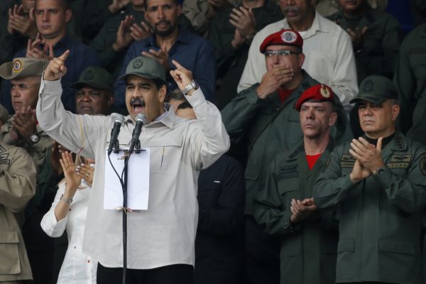 FILE - In this April 13, 2019 file photo, Venezuela's President Nicolas Maduro, speaks flanked by Defense Minister Vladimir Padrino Lopez, right, and Gen. Ivan Hernandez, second from right, head of both the presidential guard and military counterintelligence in Caracas, Venezuela. The Associated Press has learned that at least twice since 2016, the U.S. government missed chances to cultivate relations with regime insiders, including Padrino and Hernández, who National Security Adviser John Bolton said backed out of a plan to topple Maduro. (AP Photo/Ariana Cubillos, File)