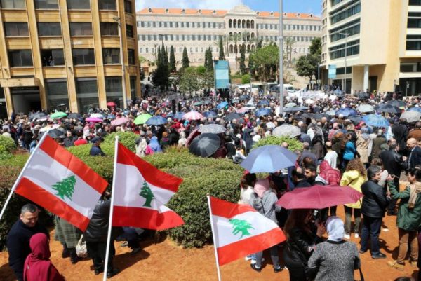 Public sector workers hold Lebanese flags during a protest against cuts to their salaries in downtown Beirut, April 17. (Reuters)