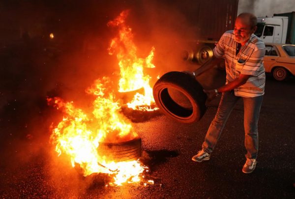 A Lebanese army veteran burns tires during a protest over a state budget that includes a provision taxing their pensions, in Naameh, south of Beirut, Lebanon June 27, 2019. REUTERS/Aziz Taher 