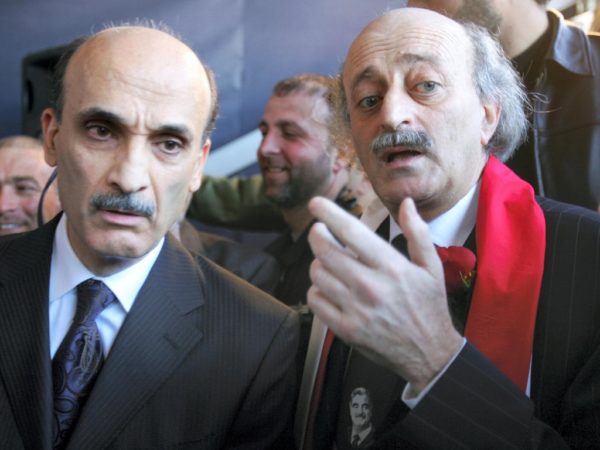 Walid Jumblatt and Samir Geagea at a mass gathering to mark the first anniversary of the assassination of Lebanese statesman Rafic Harir in central Beirut 14 February 2006. The two figures were then members an alliance that helped drive out Syrian troops from Lebanon through non-violent resistance. Hezbollah has refused to hand four of its operatives suspected for involvement in the assassination to a United Nations tribunal in The Hague.AFP
