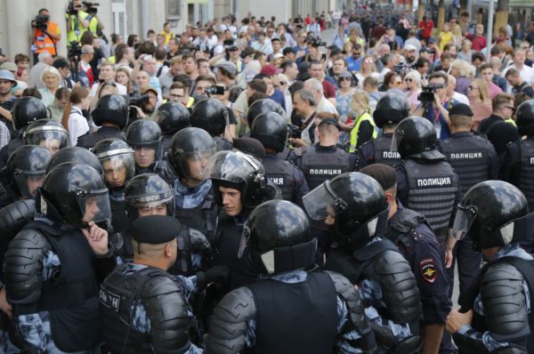 Russia Opposition Protest Police block a street prior to an unsanctioned rally in the center of Moscow, Russia, Saturday, July 27, 2019. Police have begun arresting people outside the Moscow mayor's office ahead of a planned protest. OVD-Info, an organization that monitors political arrests, said about 50 people had been detained by 1:30 p.m. Saturday, a half-hour before the protest against the exclusion of opposition figures from the ballot for city council elections was to start. (AP Photo/Alexander Zemlianichenko) 