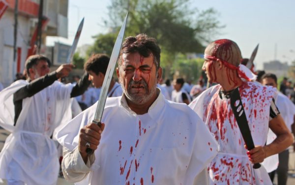 Iraqi men flagellate themselves with swords during the mourning procession on the tenth day of Muharram which marks the day of Ashura, in the Iraqi capital Baghdad on September 10, 2019. (SABAH ARAR/AFP/Getty Images)