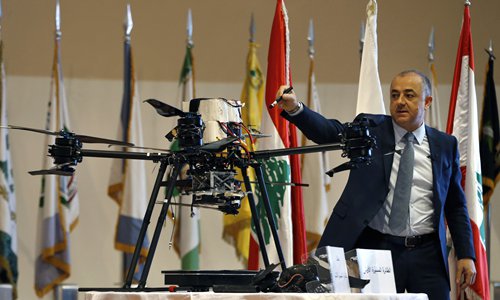 Lebanese Defense Minister Elias Bou Saab points to parts of an Israeli drone that crashed in southern Beirut last month during a press conference to announce the results of an investigation into the incident, at the Lebanese Defense Ministry, in Yarzeh near Beirut, Lebanon, Thursday, Sept. 19, 2019. The investigation has concluded that two Israeli drones that crashed in the Lebanese capital last month were on an attack mission, one of them armed with 4.5 kilograms of explosives. (AP Photo/Bilal Hussein)