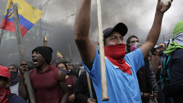 Anti-government protesters, including indigenous people, clash with police near the National Assembly in Quito, Ecuador, on Tuesday. Ecuador’s government flees capital amid furious protests over rising fuel prices 