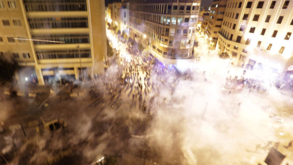 Lebanese riot police fire tear gas during a protest against government's plans to impose new taxes in Beirut, Lebanon.