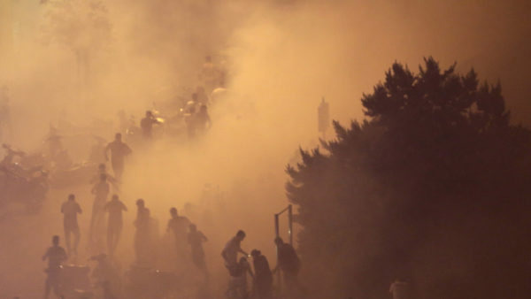 Lebanese riot police fire tear gas during a protest against government's plans to impose new taxes in Beirut, Lebanon.CREDIT:AP