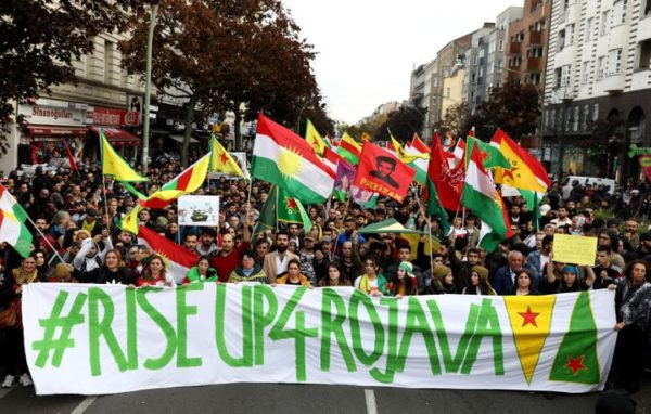 Kurdish protesters in Berlin, Germany, carry a banner during a demonstration on Oct. 12 against Turkey’s military action in northeastern Syria.