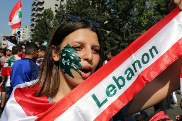 Lebanese women take part in a demonstration in A demonstrator takes part in an anti-government protest in the southern city of Nabatiyeh, Lebanon October 21, 2019. (Reuters) 