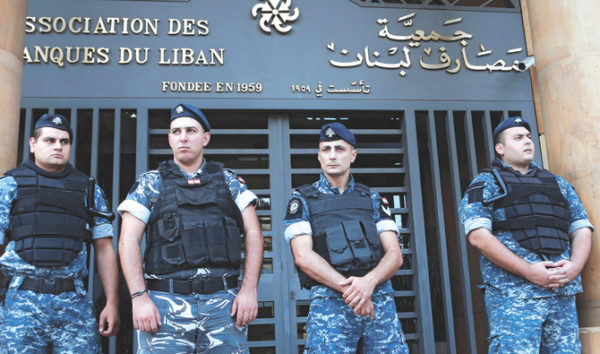 Lebanese police stand outside the entrance of the Association of Banks in downtown Beirut