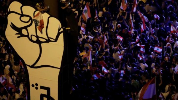 Demonstrators hold Lebanese flags as they gather at Martyrs' square during ongoing anti-government protests in downtown Beirut, Lebanon on November 3, 2019. (Reuters)