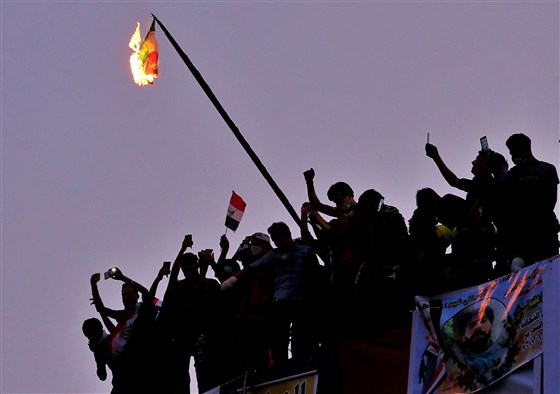 Iraqi anti-government protesters burn the Iranian flag during a demonstration in Baghdad, Iraq,  last  Tuesday. Hadi Mizban / AP