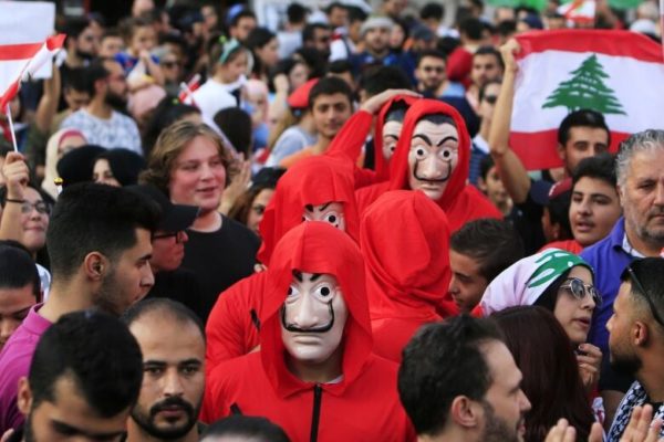 Demonstrators wearing costumes take part in an anti-government protest in the port city of Sidon (Ali Hashisho/Reuters)