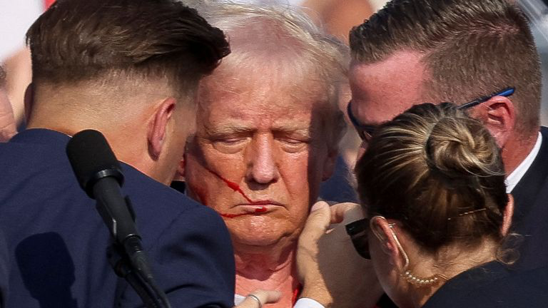 Trump was  rushed from election rally  after  he was shot in the ear