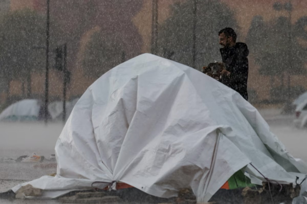 In heavy rain and strong , Lebanese fleeing war huddle under makeshift shelters